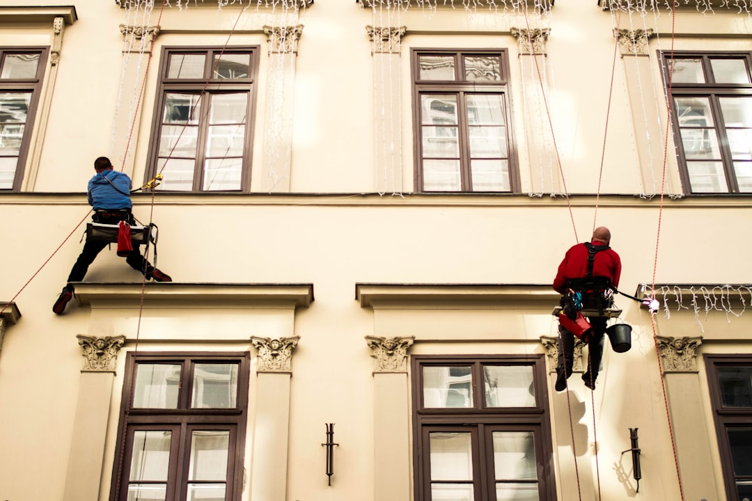 a-man-on-a-rope-attached-to-the-side-of-a-building-1xut1rlayvy